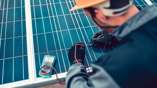 Engineer measuring solar panel electrical output