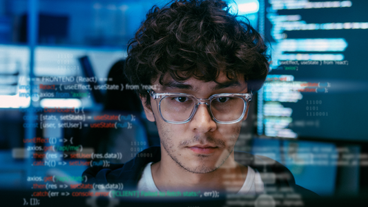 Engineer reviewing code on computer screen