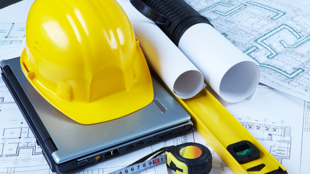 Engineering project tools and construction plans on a desk