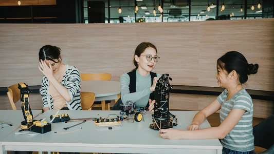 Engineers building robotics project together