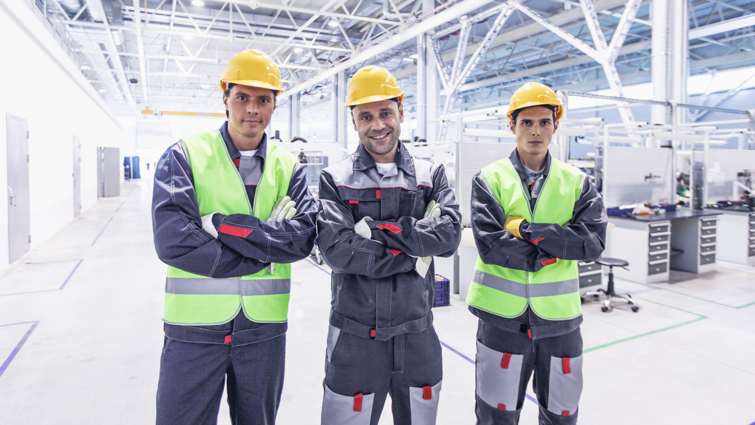 Engineers in industrial facility wearing safety helmets