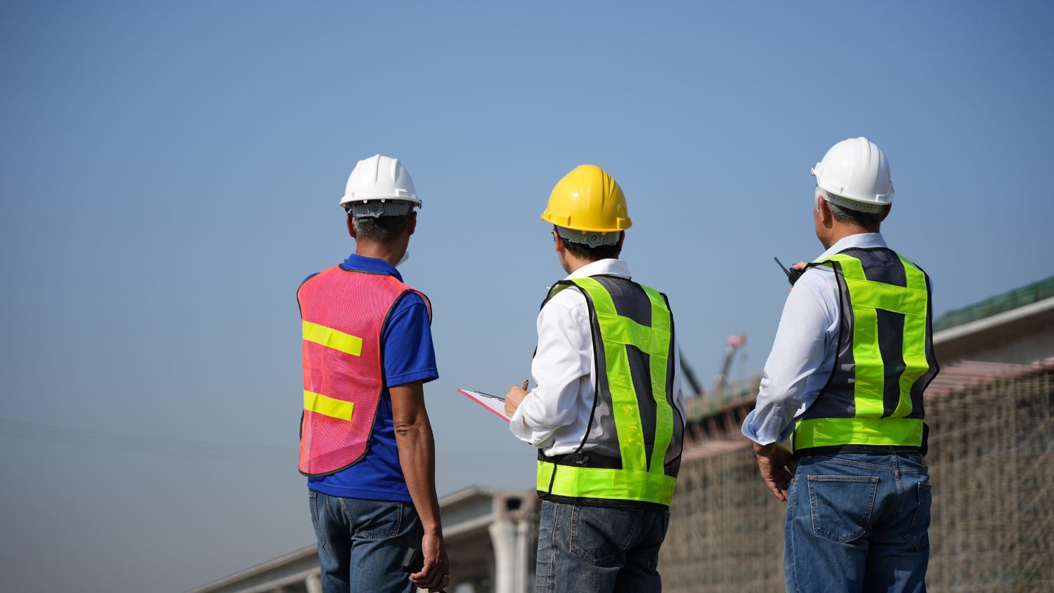 Engineers reviewing bridge construction at transportation site