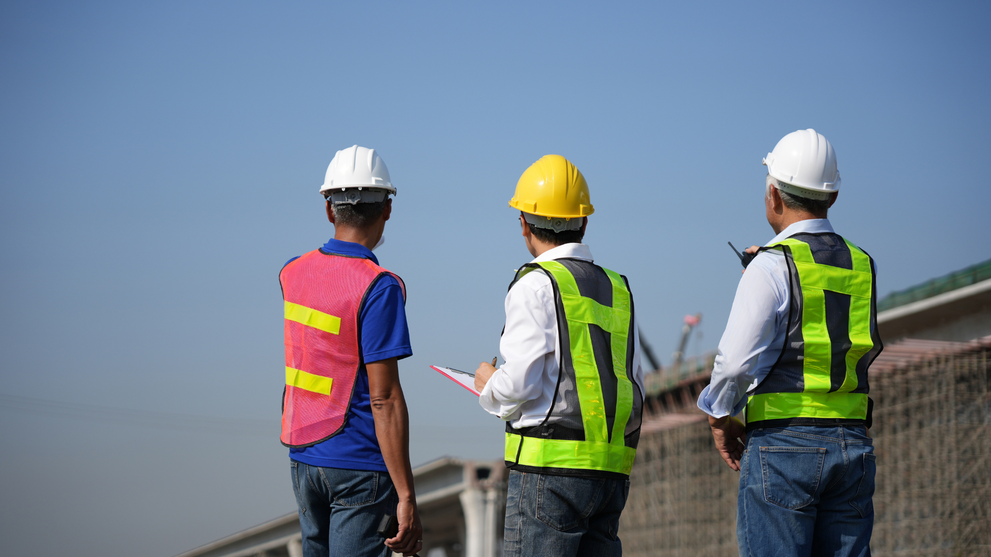 Engineers reviewing bridge construction at transportation site