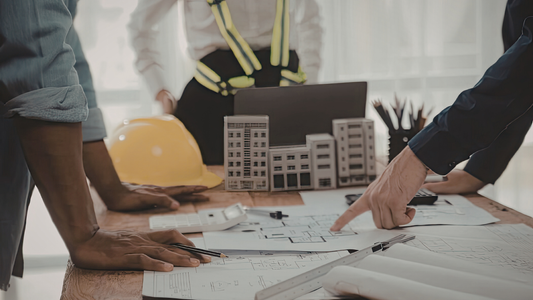 Engineers reviewing construction plans at project site