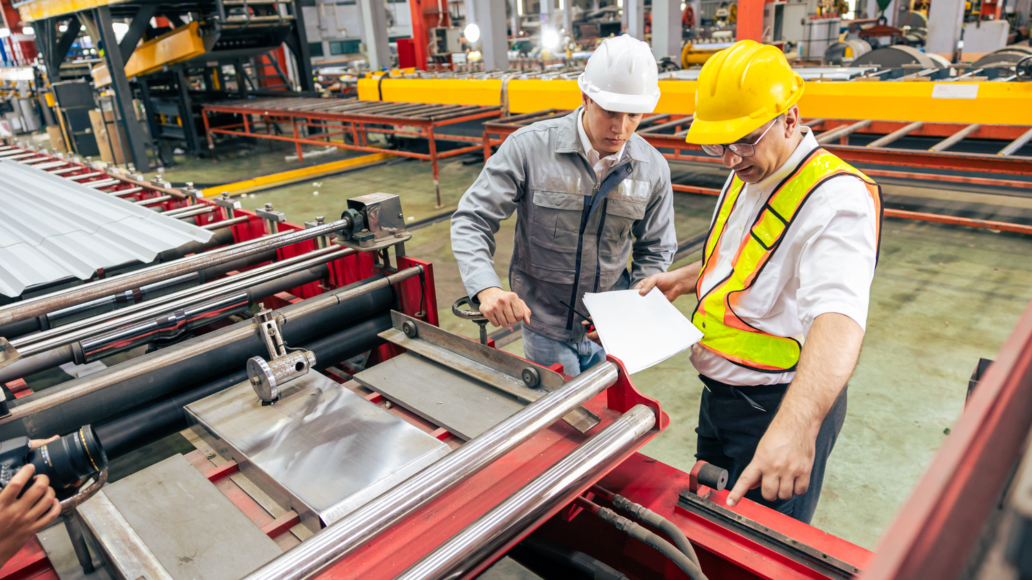Engineers reviewing machinery and training documentation