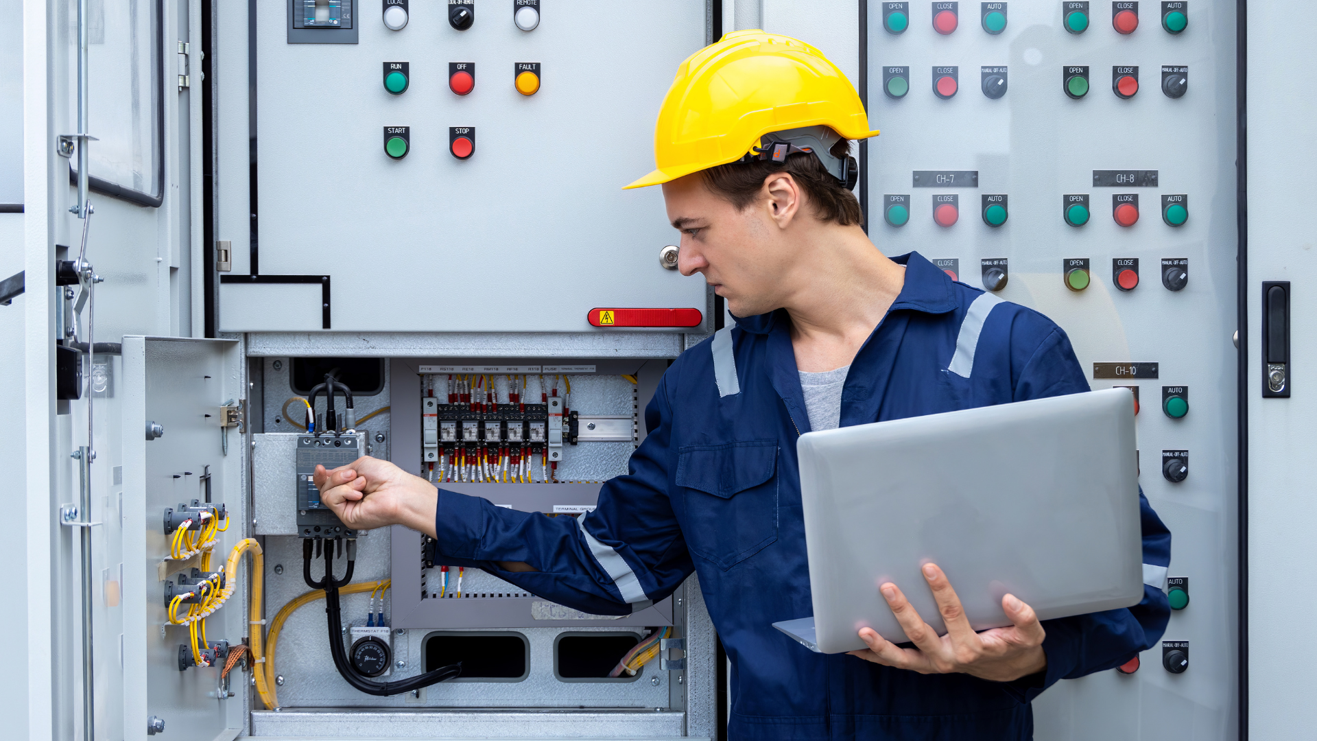 Professional engineer inspecting electrical control panel