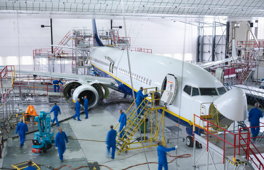 Transportation engineers inspecting aircraft during maintenance